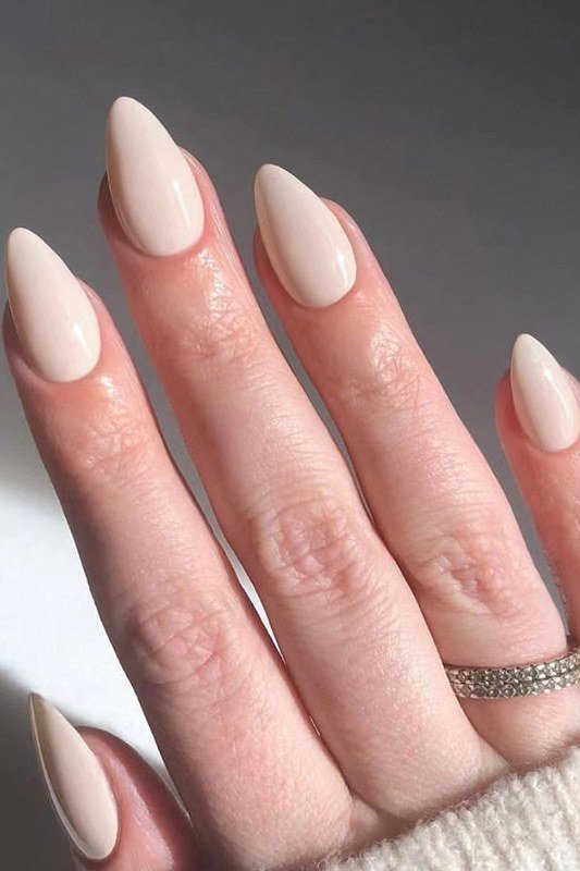 Long almond milky white nails with ring for women over 50