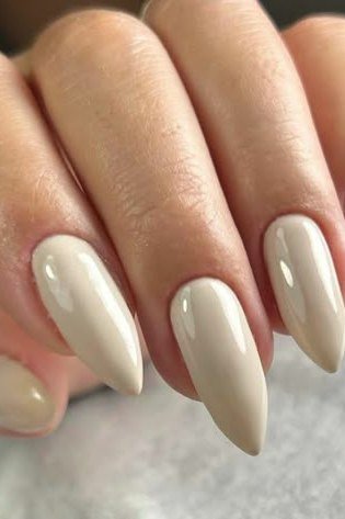 Long almond ivory white nails glossy close-up for women over 50