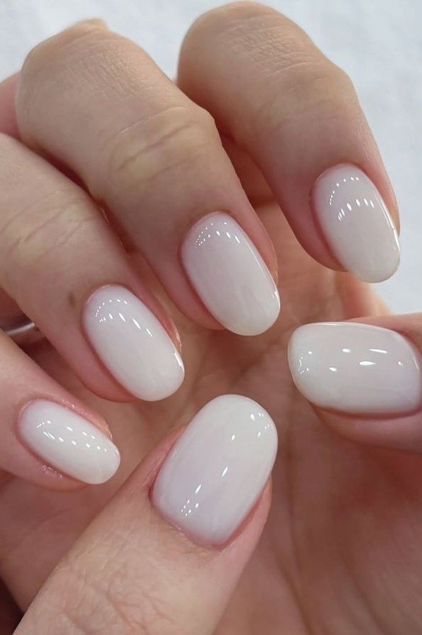 Oval milky white nails high gloss front view for women over 50