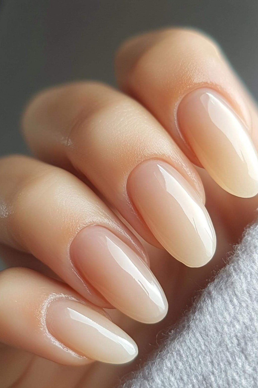 Almond milky nude nails high gloss close-up for women over 50