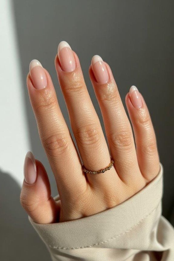 Almond french tip nails in beige sleeve for women over 50