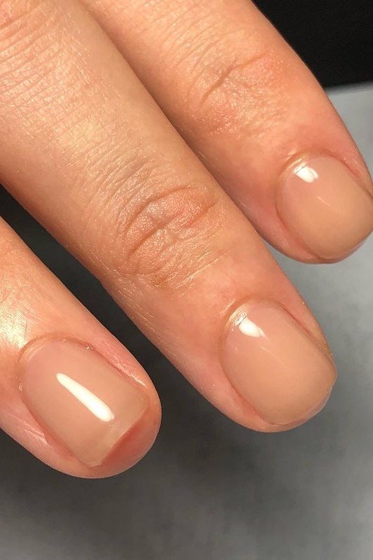 Peachy nude oval nails glossy macro for women over 50