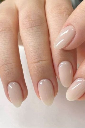 Milky nude oval nails glossy macro close-up for women over 50