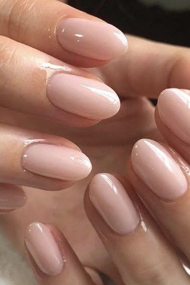 Milky pink almond nails glossy close-up for women over 50