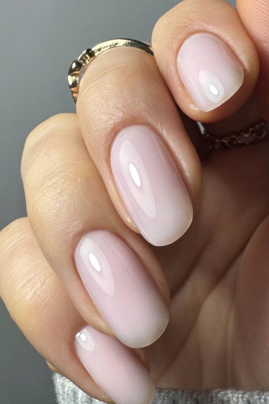 Milky pink oval nails glossy macro for women over 50