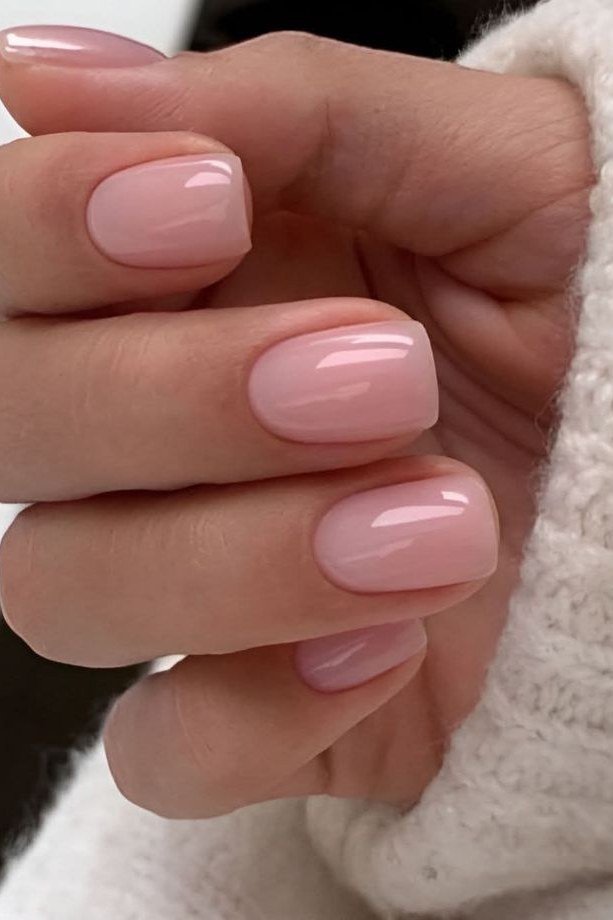 Pink nude oval nails clasped hands front view for women over 50