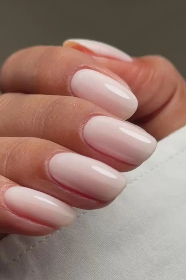 Milky pink oval nails glossy close-up for women over 50