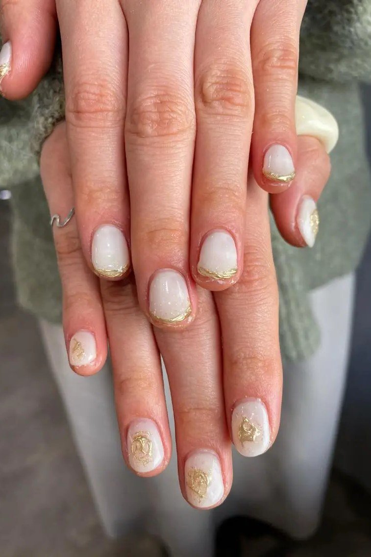 White with gold foil french tips - nail art for women over 50