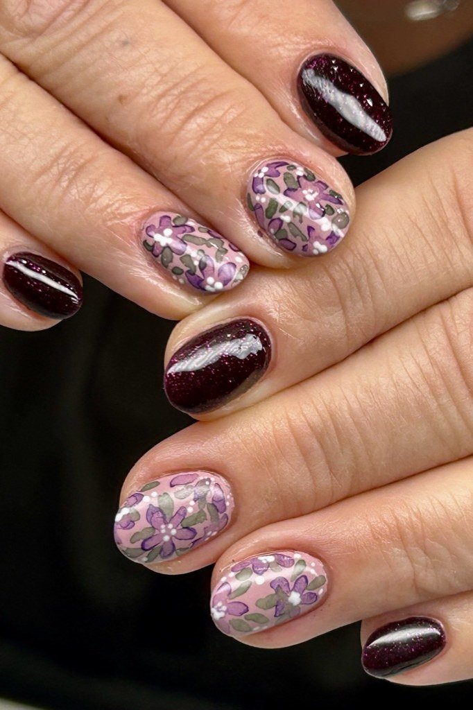 Burgundy with floral art accents, mature hands - nail art for women over 50