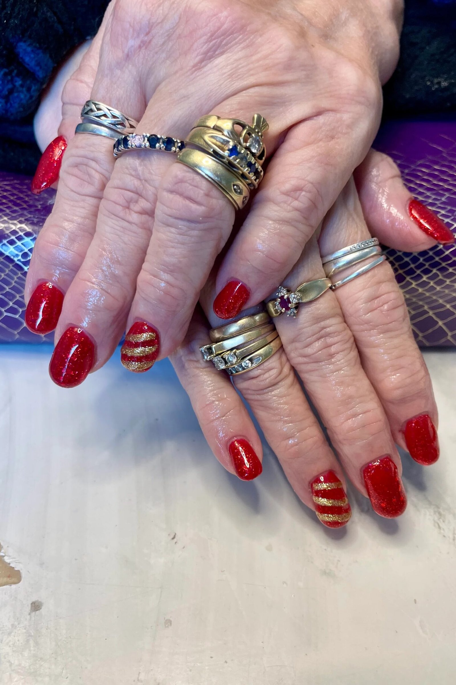 Red with gold stripe accents, old hands - nail art for women over 50