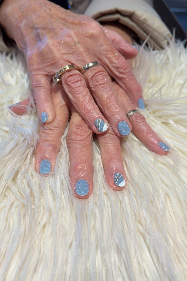 Light blue with silver glitter accents, old hands - nail art for women over 50