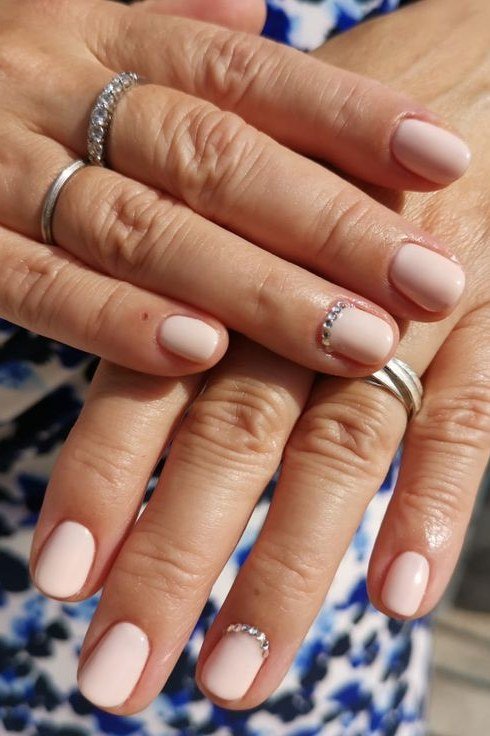 Nude with tiny crystal cuticle accents, mature hands - nail art for women over 50