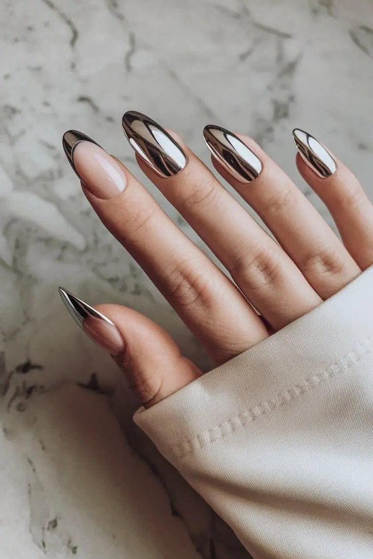 Nude almond nails with silver chrome french tips, mirror tips