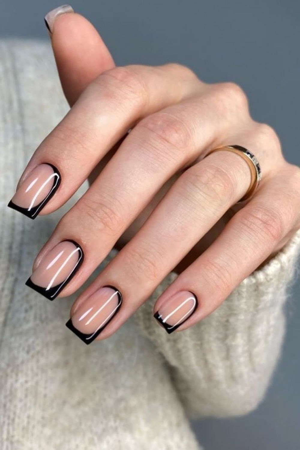 Nude nails with black french tips, square shape