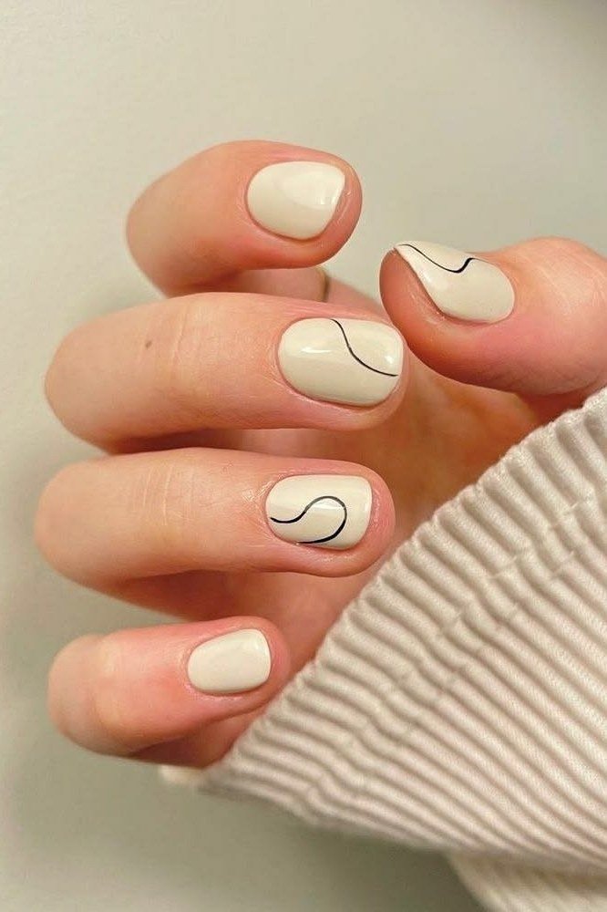 White almond nails with black swirl line art