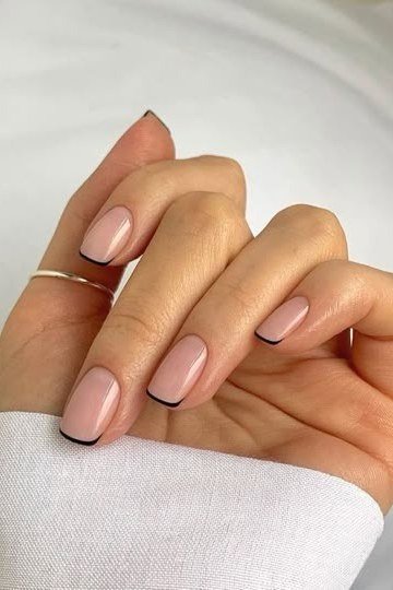 Nude almond nails with thin black french tip lines