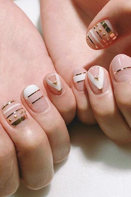 Nude nails with gold and white stripe art