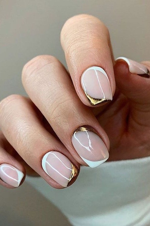 White nails with gold cuff tips, almond