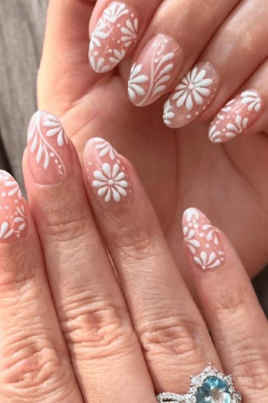 Nude almond nails with white daisy art