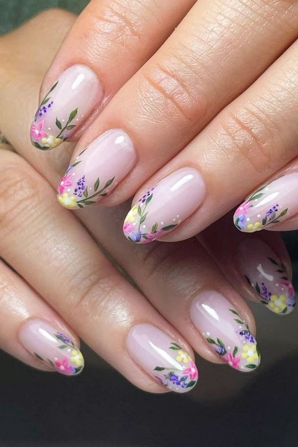 Pink almond nails with colorful painted floral tips