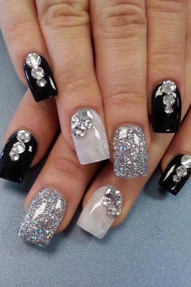 Black and white nails with glitter and rhinestone accents