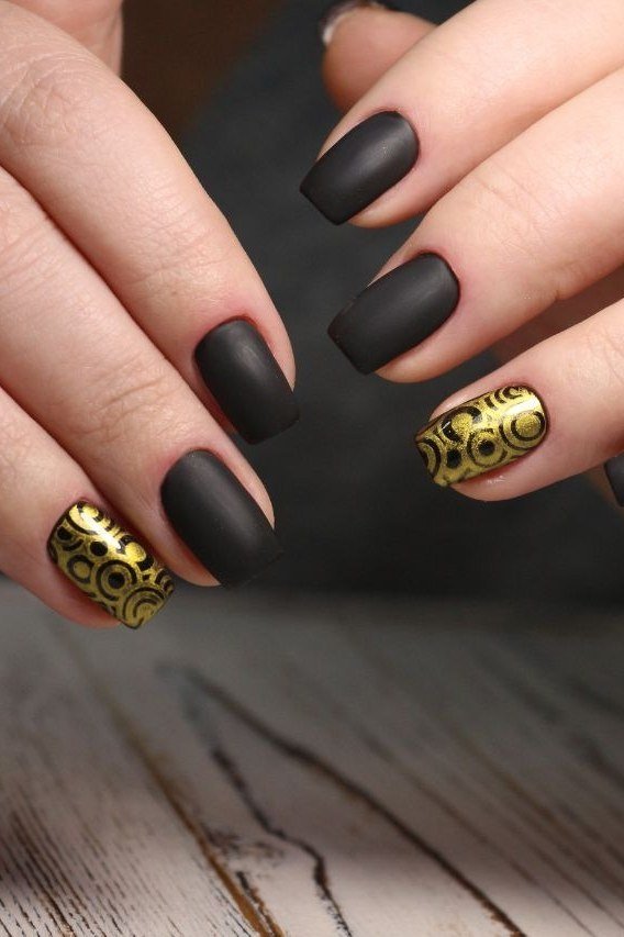 Matte black nails with gold filigree accent nails