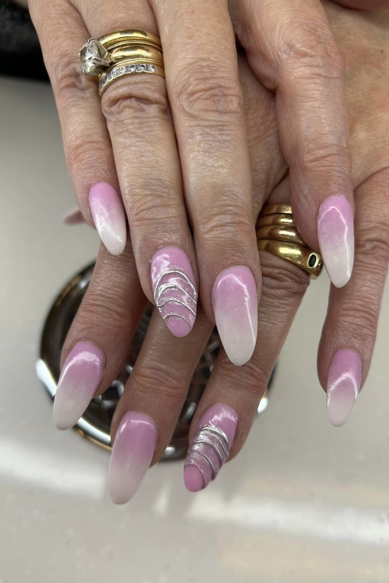 Lavender french tips on almond nails, mature hands with gold rings