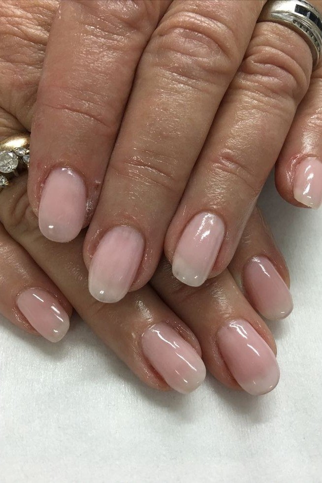 Short nude oval nails, older hands, glossy