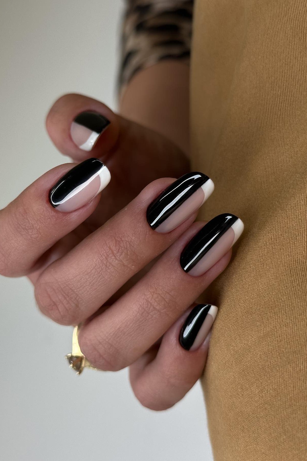 Nude nails with black and white split-tip geometric art