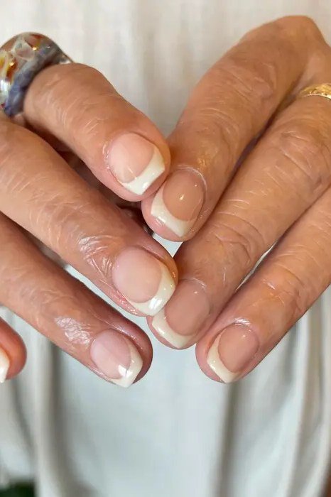 Short classic French tips, neat and understated for women over 50