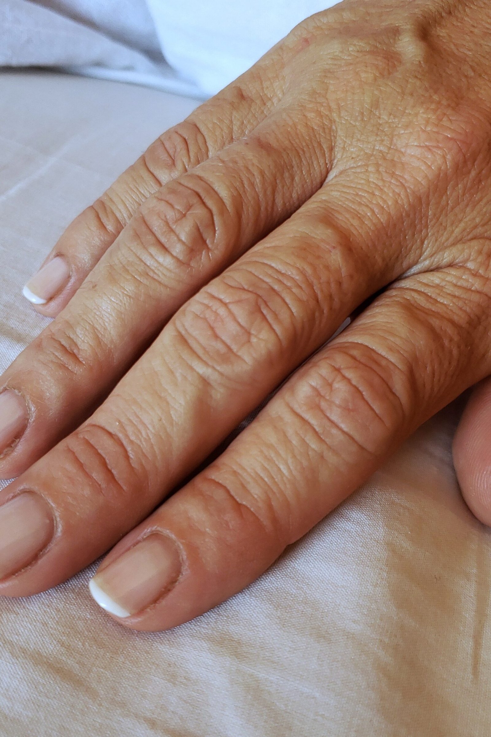 Natural French manicure with thin white tips for women over 50