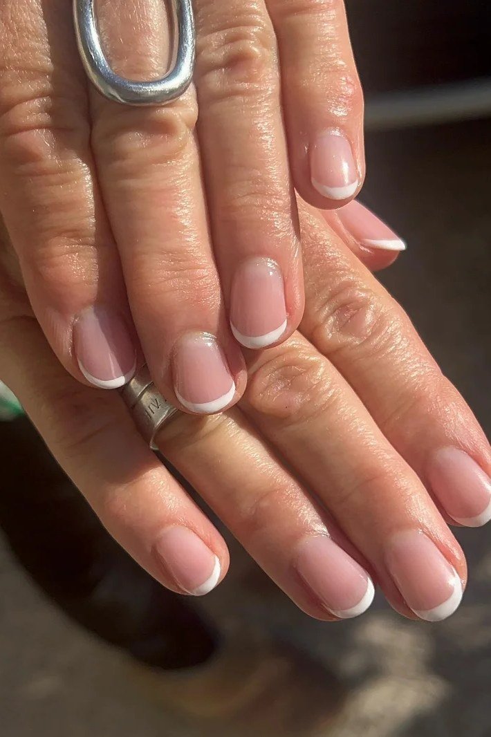 Short pink-based French tips for women over 50