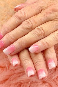Soft pink-and-white ombre French nails for older women