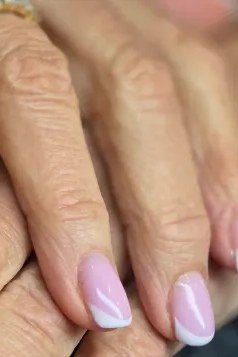 Lilac-pink ombre French nails for women over 50