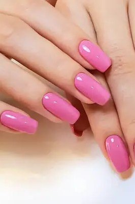 Vivid hot pink almond nails for women over 50