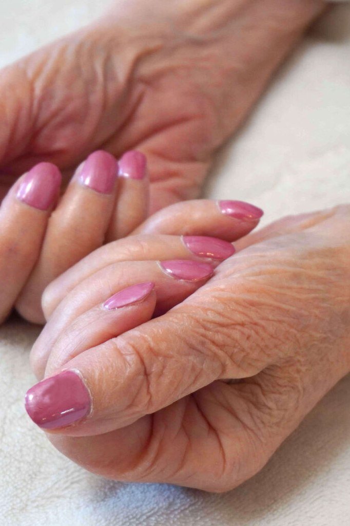 Glossy soft-pink oval nails for women over 50