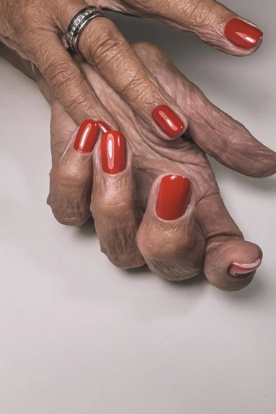 Burnt orange nail polish for women over 70 on older hands