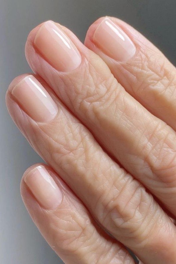 High gloss nude nails closeup for women over 70