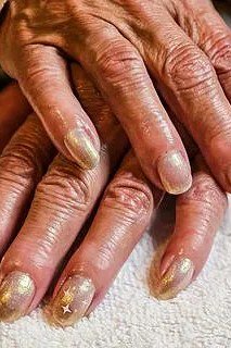 Full metallic gold nails for women over 70 on older hands