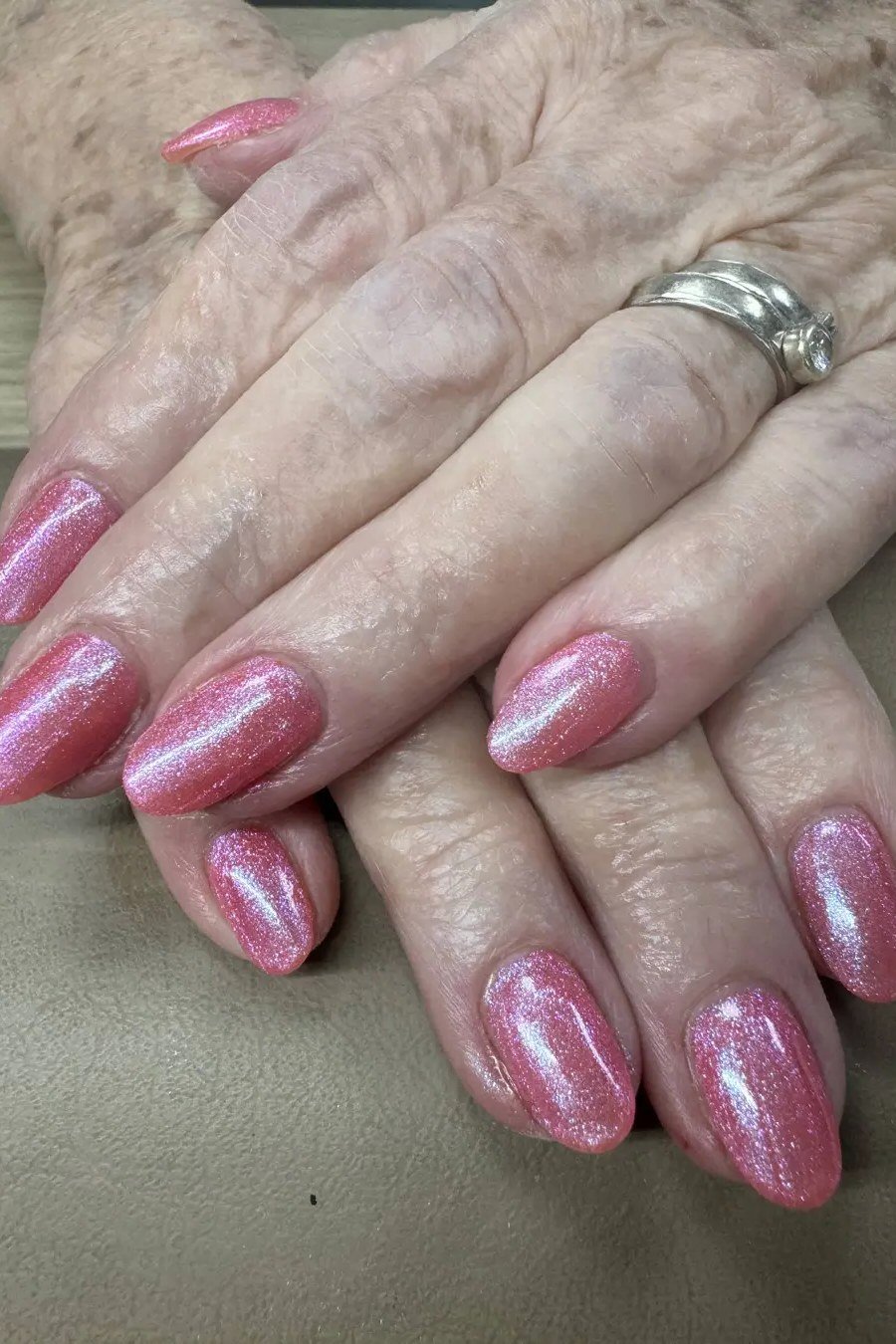 Shimmery pink nails for women over 70 on older hands