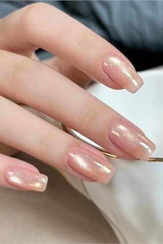 Champagne pink jelly almond nails, glossy, hand with cup - jelly nail idea for women over 60