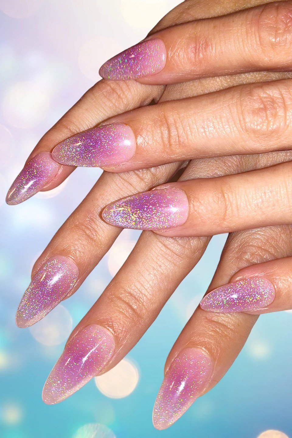 Lavender glitter jelly almond nails on hand, sparkly translucent - jelly nail idea for women over 60
