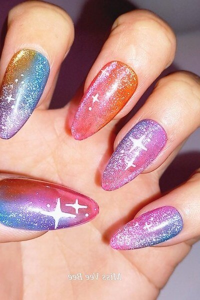 Rainbow glitter jelly nails with white plus-sign nail art, almond - jelly nail idea for women over 60