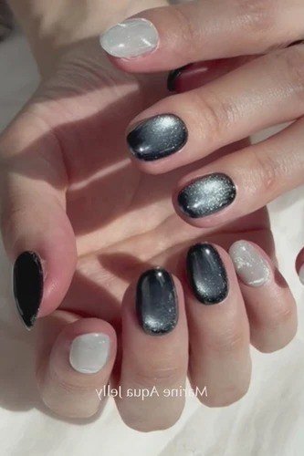 Black and blue cat-eye jelly nails, short round, on hand - jelly nail idea for women over 60