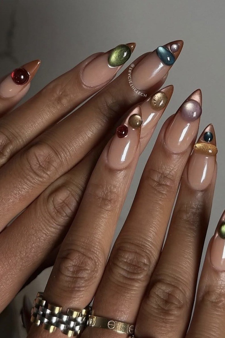Brown jelly almond nails with tiny gold bead charms, older hands - jelly nail idea for women over 60