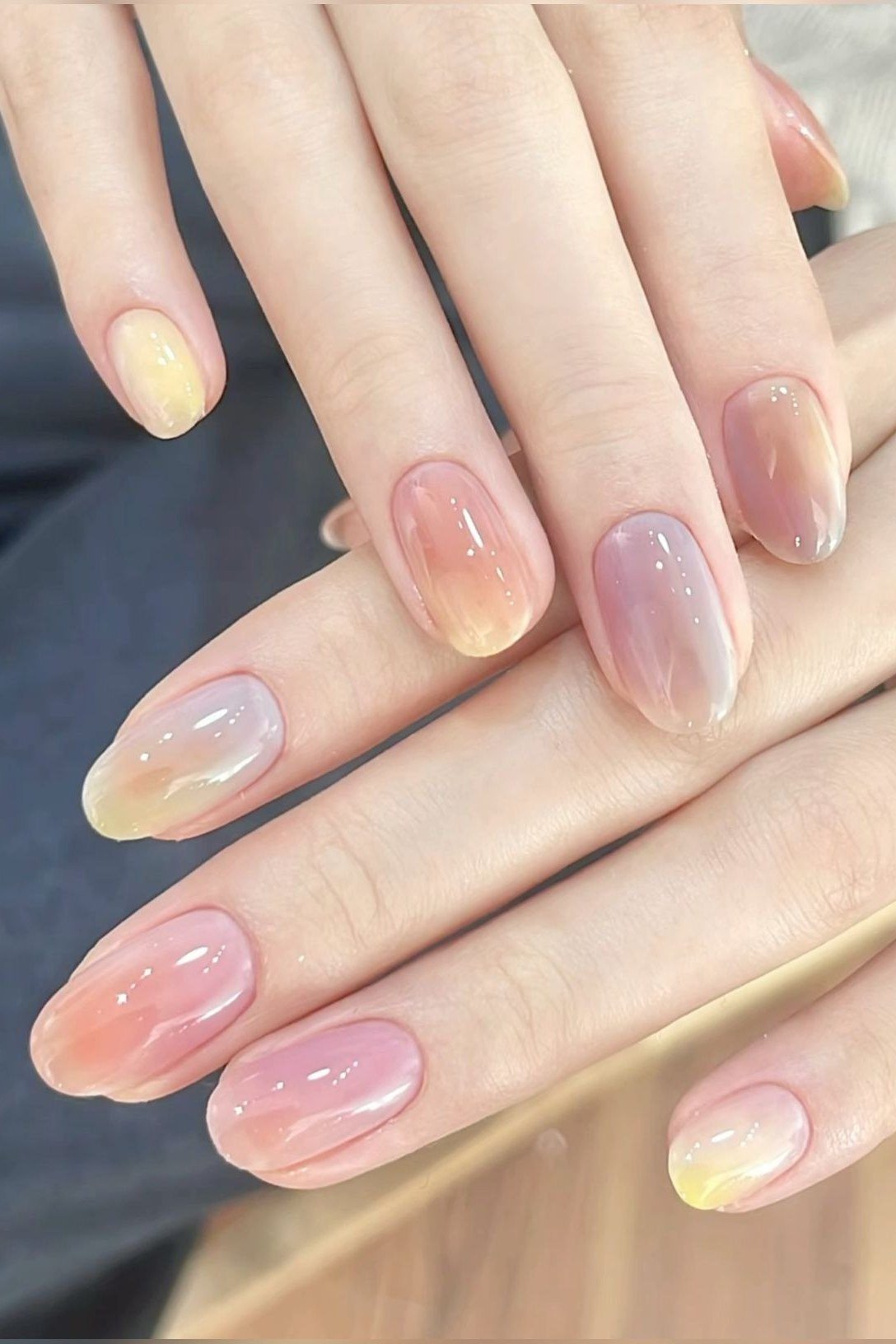 Pastel yellow and pink jelly nails, short almond, on hand - jelly nail idea for women over 60