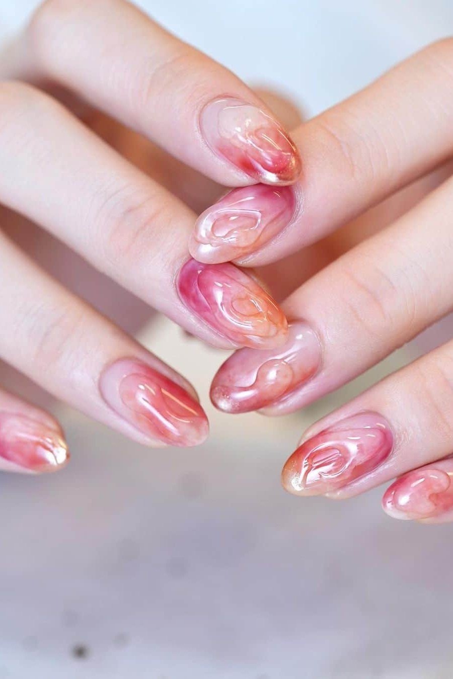 Red-pink marble jelly nails, long almond - jelly nail idea for women over 60