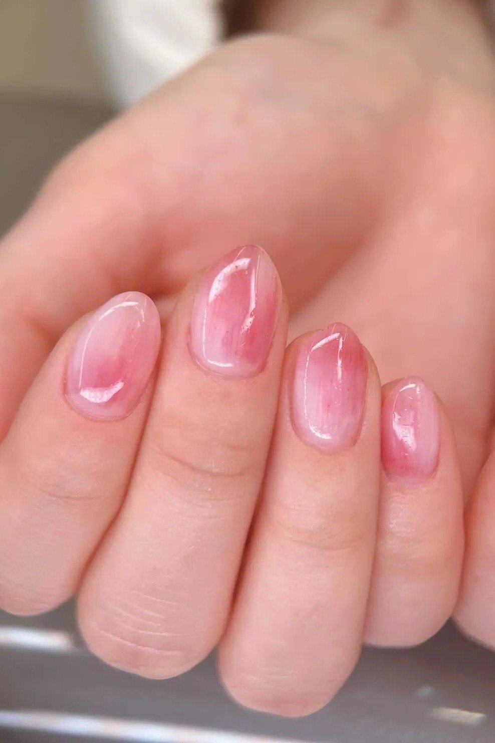 Pink jelly nails, short, palm-up hands view - jelly nail idea for women over 60