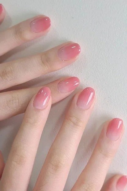 Pink blush jelly nails, short oval, on hand - jelly nail idea for women over 60