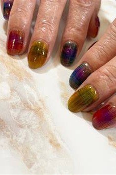 Multicolor jelly nails on older hands, green purple red - jelly nail idea for women over 60